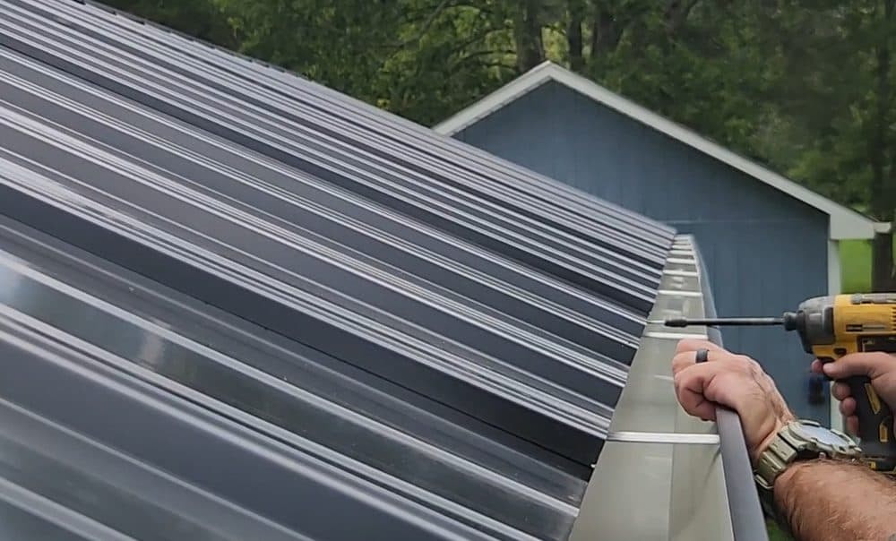 Installing 6-inch seamless gutters on a standing seam metal roof in Alamance County NC, Freedom Gutters