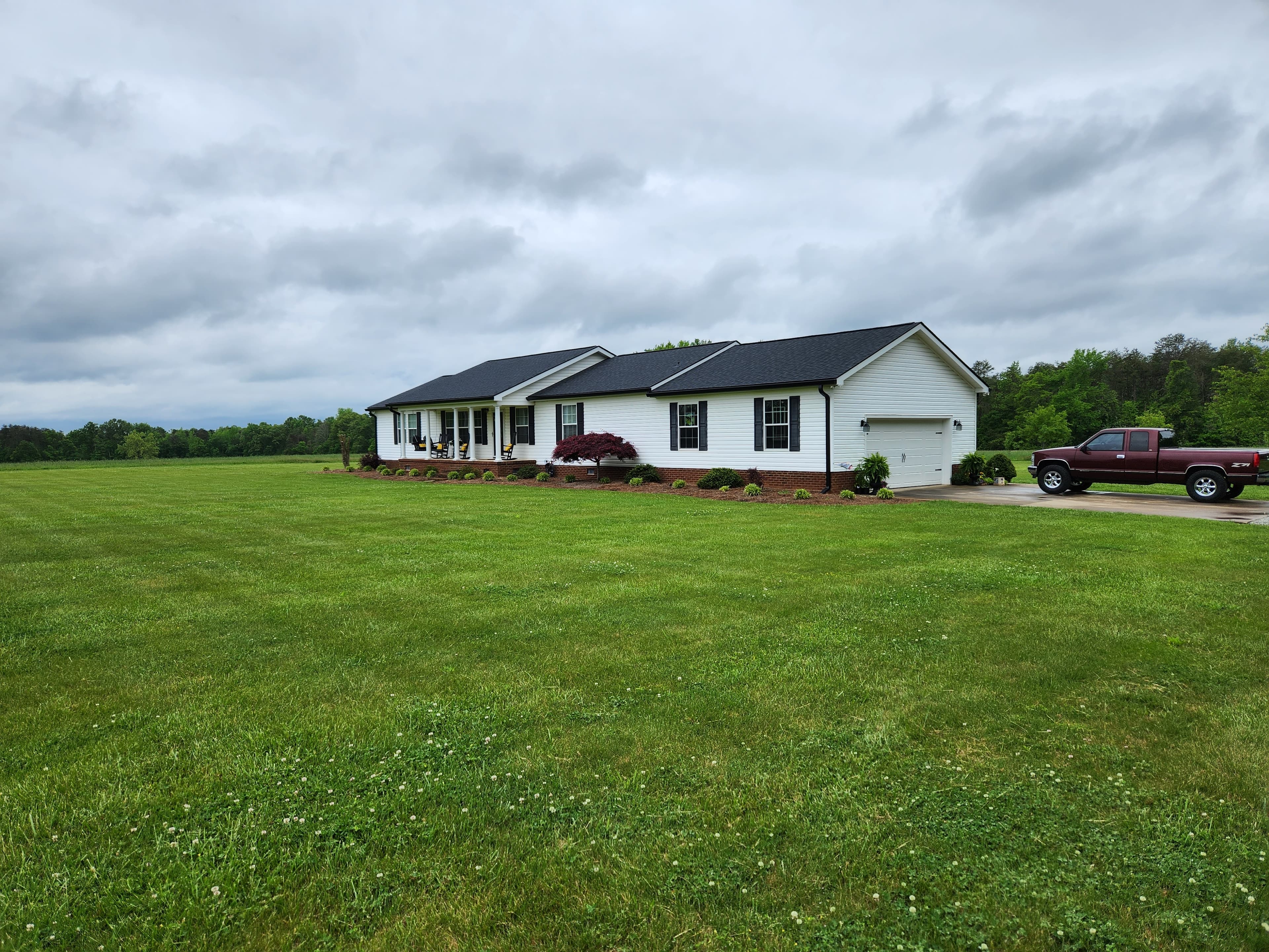 White ranch home with black seamless gutters in rural NC