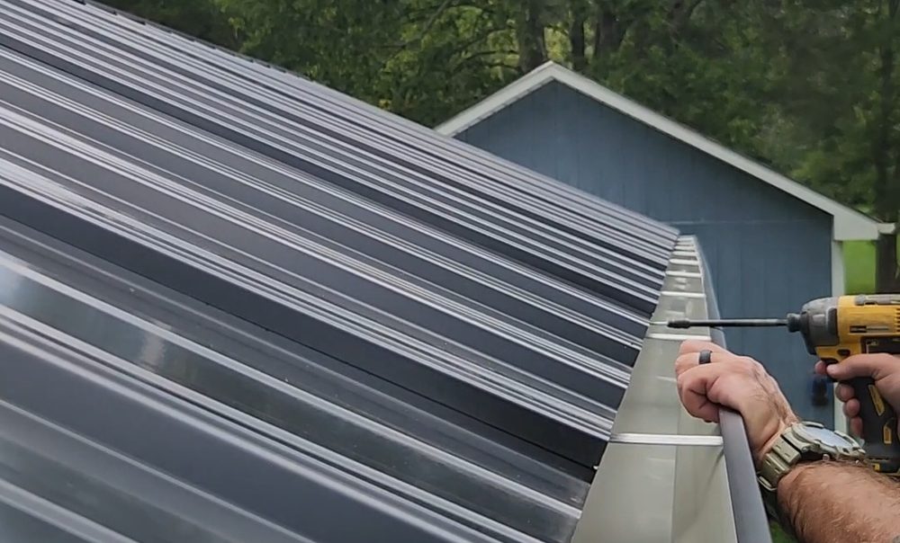 Installing 6-inch seamless gutters on a standing seam metal roof in Alamance County NC, Freedom Gutters