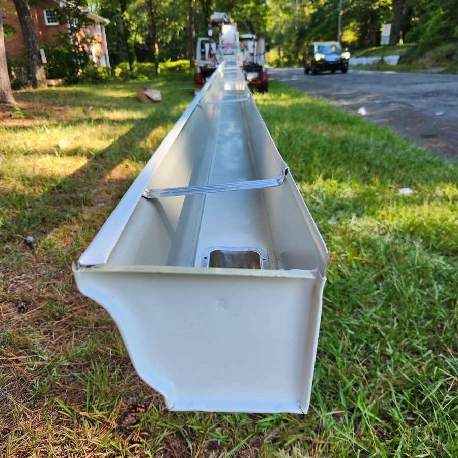 End view of K-style seamless aluminum gutter showing channel depth and water capacity, Freedom Gutters Mebane NC