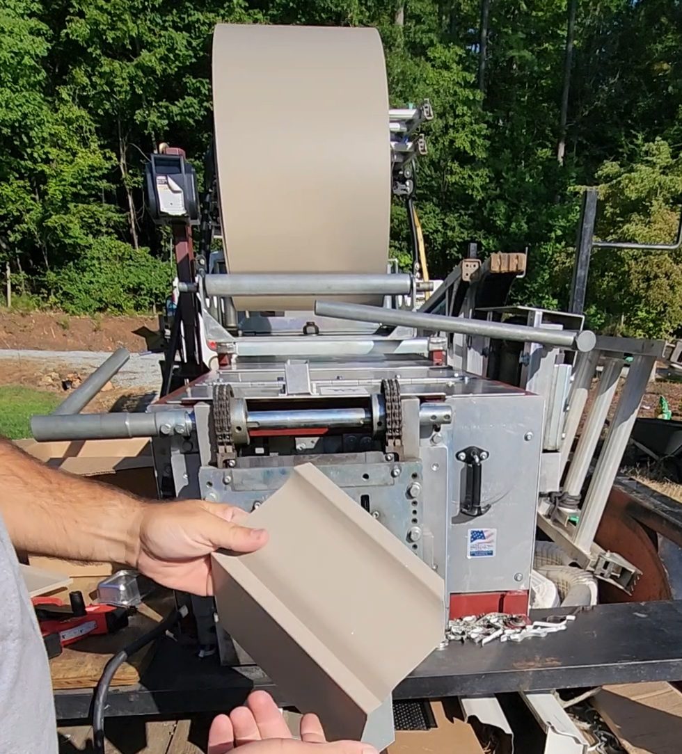 Freedom Gutters roll-forming machine forming seamless aluminum gutter on-site, Alamance County NC